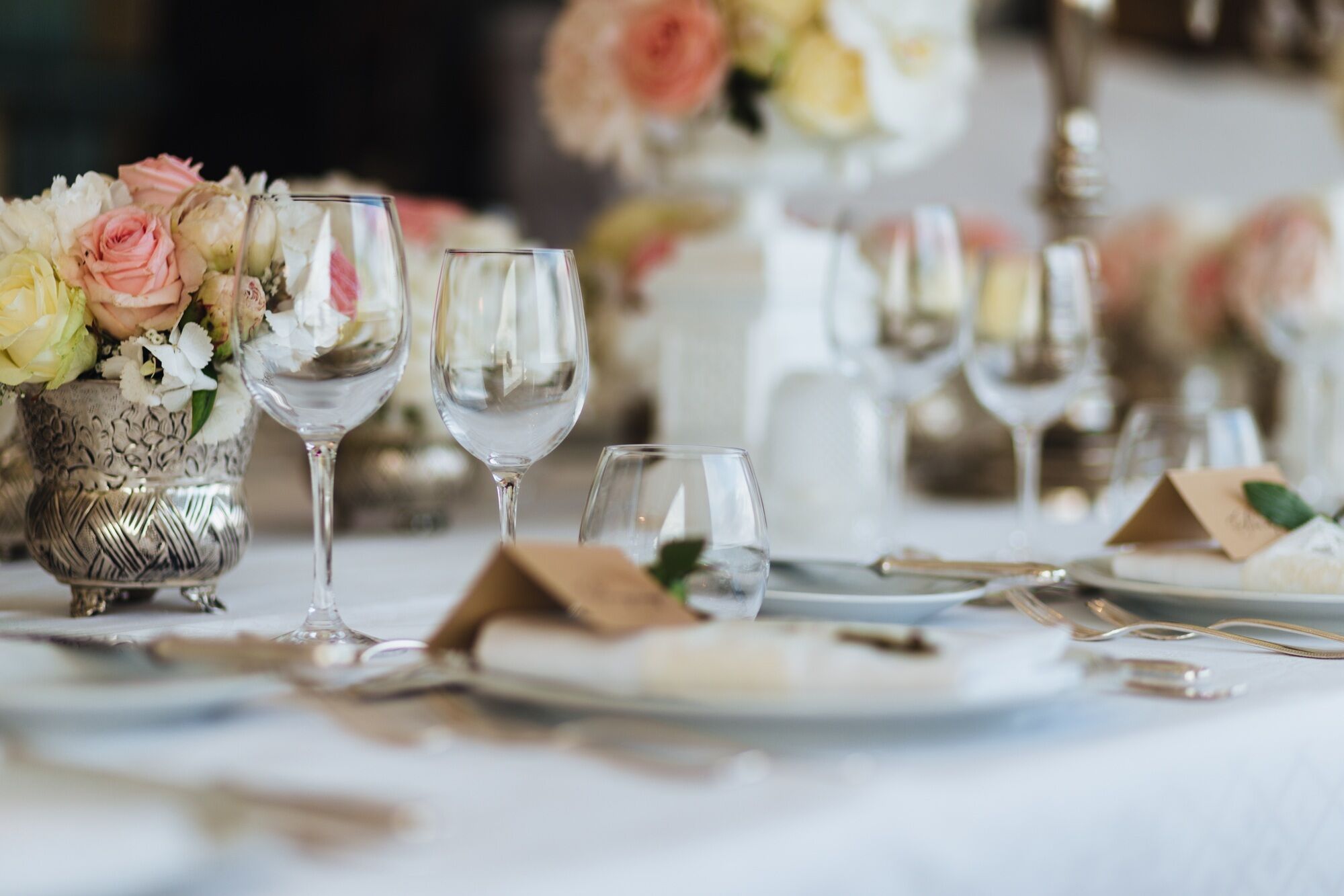 Beautiful table served with glassware and cutlery, decorated with flowers