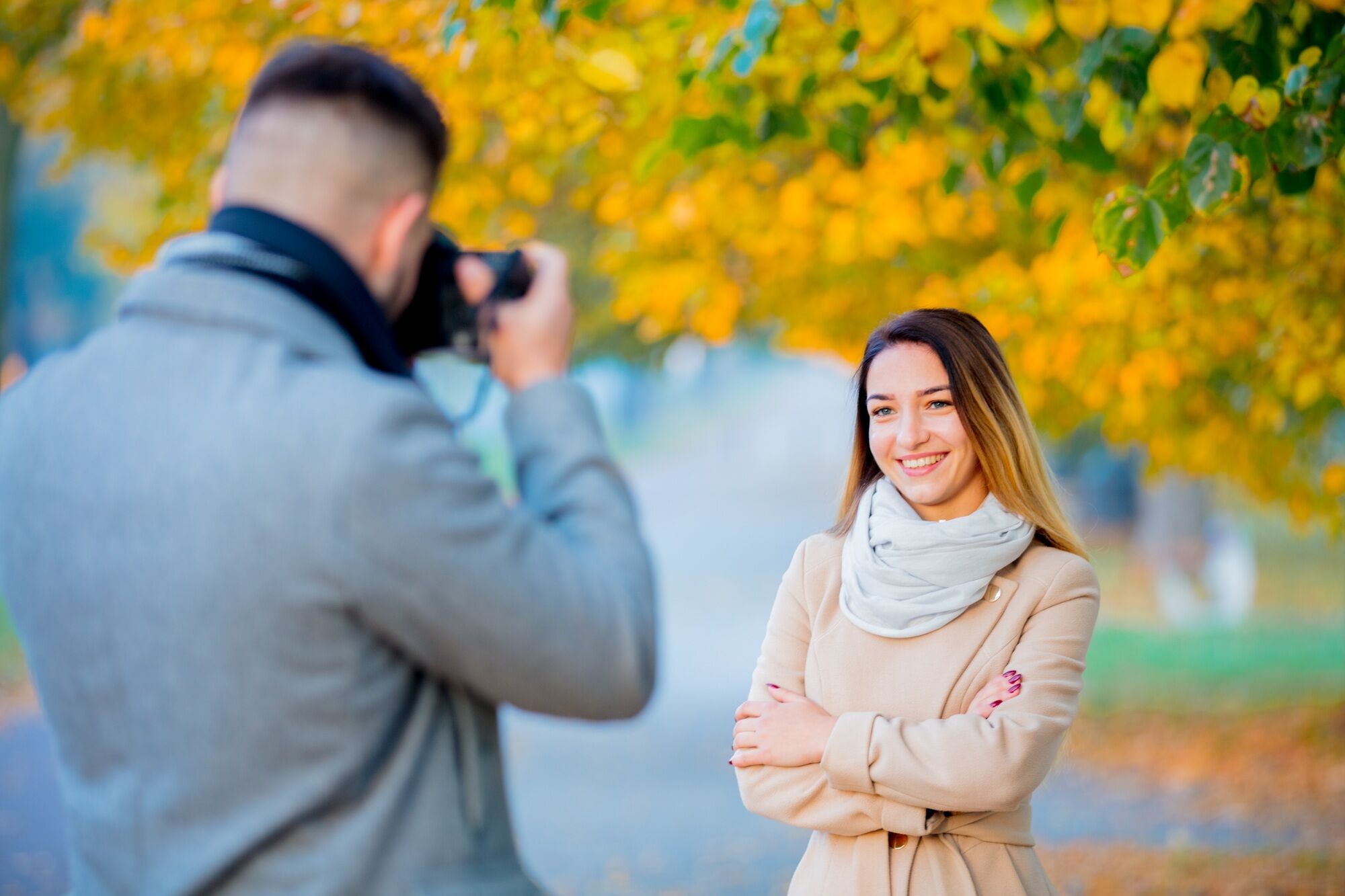 Young photographer with camera and model